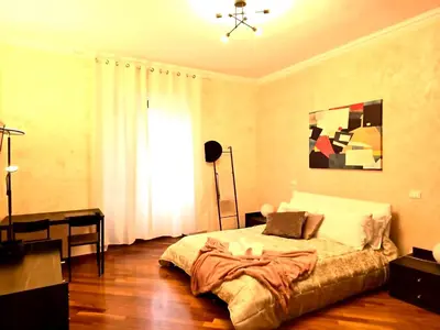 a bedroom with a bed and a desk and a window at Domus Prestige Vaticano 