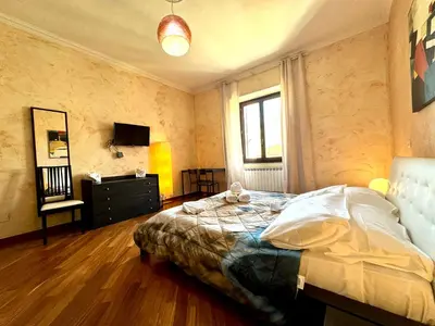 a bedroom with a bed and a television in it at Domus Prestige Vaticano 