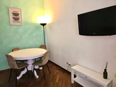 a small room with a table and a flat screen tv at Domus Prestige Vaticano 