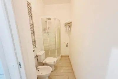 a bathroom with a toilet and a glass shower at Bed&BikeRome ANGELICO in Rome