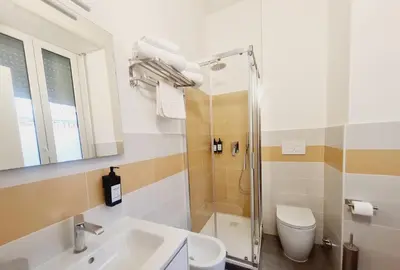 a bathroom with a shower and a sink and a toilet at Bed&BikeRome ANGELICO in Rome