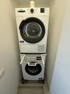 a washer and dryer sitting in a room at Bed&BikeRome ANGELICO in Rome