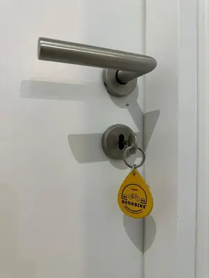 a key chain is attached to a white door at Bed&BikeRome ANGELICO in Rome