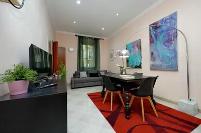 a living room with a table and chairs at Vatican Museums Art Apartment in Rome