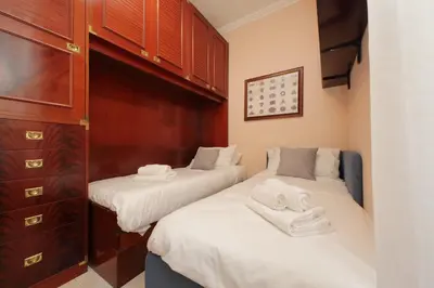 a bedroom with two beds and a dresser at Vatican Museums Art Apartment in Rome