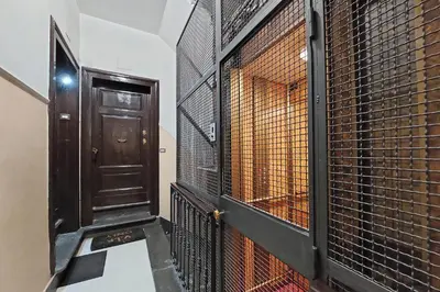 a hallway with a door and a cat cage at Vatican Museums Art Apartment in Rome