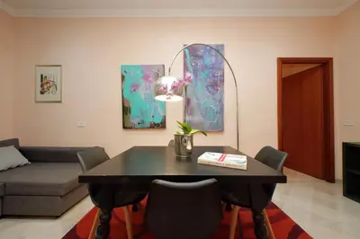 a living room with a table and a couch at Vatican Museums Art Apartment in Rome