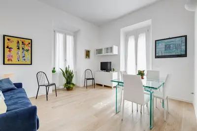 a living room with a blue couch and a table at Casa di Zio Colosseo in Rome