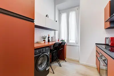 a kitchen with a washer and dryer in a room at Casa di Zio Colosseo in Rome