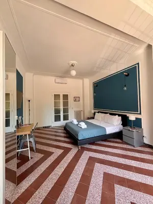 a bedroom with a bed and a large wall at The Place Strozzi in Rome