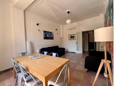 a living room with a table and a couch at The Place Strozzi in Rome