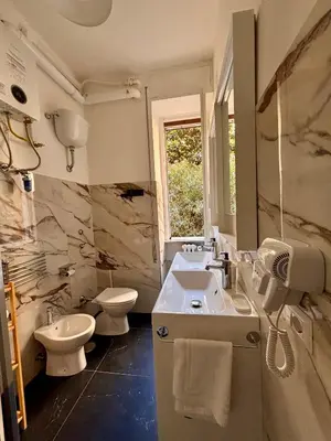 a bathroom with a sink and a toilet at The Place Strozzi in Rome