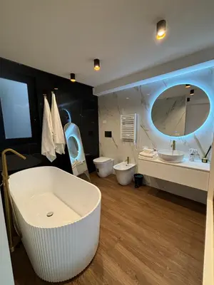 a bathroom with two sinks and a tub and two toilets at Atrium Regal Room in Rome