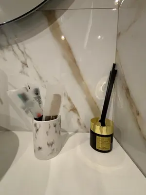 a white counter with a toothbrush and a cup with a wand at Atrium Regal Room in Rome