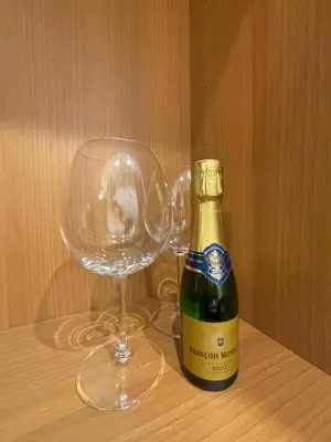 a bottle of champagne and a wine glass on a table at Atrium Regal Room in Rome