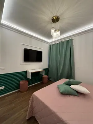 a bedroom with a bed and a flat screen tv at Atrium Regal Room in Rome