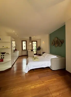 a bedroom with two beds and a green wall at Vincent's Place, Vatican City in Rome
