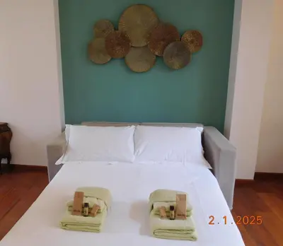 a bedroom with a bed with two towels on it at Vincent's Place, Vatican City in Rome