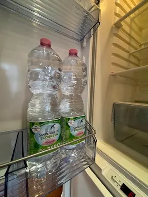 two bottles of water in an empty refrigerator at Vincent's Place, Vatican City in Rome