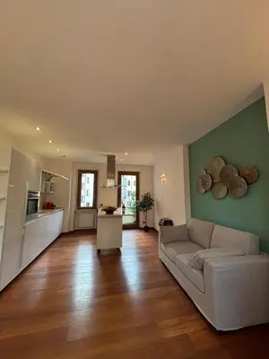 a living room with a couch and a kitchen at Vincent's Place, Vatican City in Rome