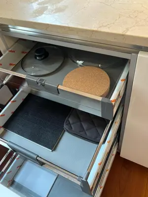 an open drawer in a kitchen with some food at Vincent's Place, Vatican City in Rome