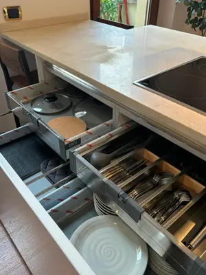 an open kitchen drawer with plates and utensils at Vincent's Place, Vatican City in Rome