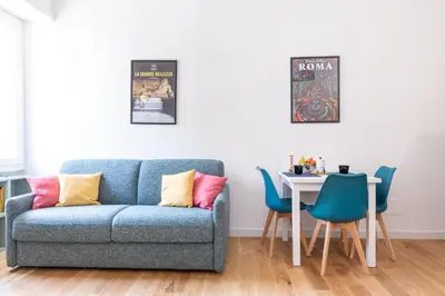 a living room with a blue couch and a table at L'Appartamentino a San Giovanni in Rome