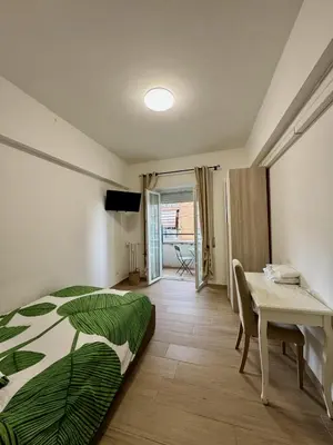 a bedroom with a bed and a desk and a table at Grazioso appartamento Tiburtina - 3 bedrooms in Rome