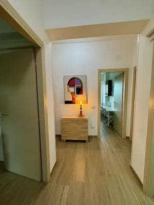 a hallway with a dresser and a painting on the wall at Grazioso appartamento Tiburtina - 3 bedrooms in Rome