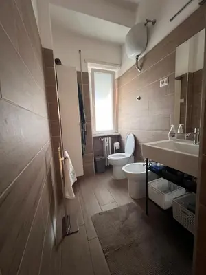 a bathroom with a toilet and a sink at Grazioso appartamento Tiburtina - 3 bedrooms in Rome