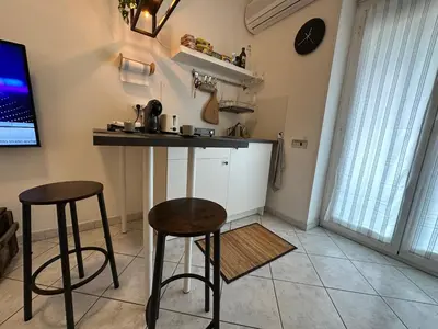 a kitchen with two stools and a bar in a room at ROMA Metro A in Rome