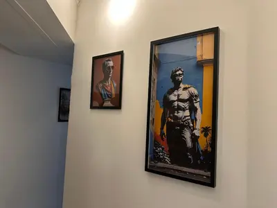 two framed pictures of a man on a wall at ROMA Metro A in Rome
