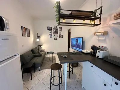 a kitchen with a table and a living room at ROMA Metro A in Rome