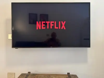 a television screen with the netflix sign on a wall at ROMA Metro A in Rome