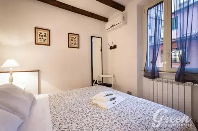 a bedroom with a bed with a towel on it at Green Apartments Rome in Rome