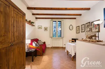 a living room with a red couch and a table at Green Apartments Rome in Rome