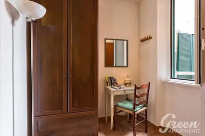 a room with a desk and a cabinet and a chair at Green Apartments Rome in Rome