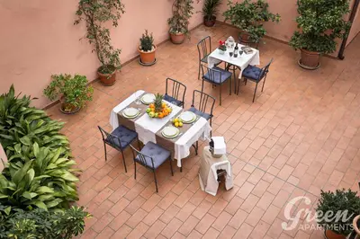 an overhead view of a patio with tables and chairs at Green Apartments Rome in Rome