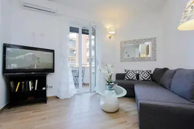 a living room with a couch and a flat screen tv at Trastevere 50DUE Apartment in Rome
