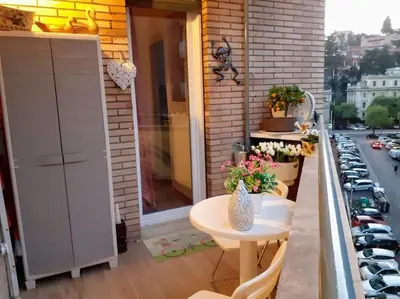 a balcony with a table and a view of a street at Trastevere 50DUE Apartment in Rome