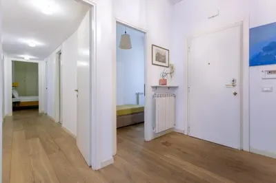 a hallway with white walls and wooden floors at Vatican Stay in Rome