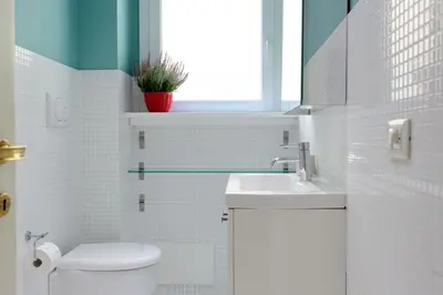 a white bathroom with a sink and a toilet at Vatican Stay in Rome