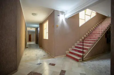 a hallway with a red staircase in a building at Vatican Stay in Rome