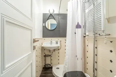a bathroom with a sink and a shower curtain at kathy Home Rome Suite in Rome