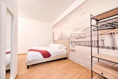 a bedroom with a bed and a painting of a street at Caesar's quarters - private rooms in Rome in Rome