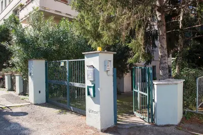 a gate with a parking meter next to a fence at Apartment in the center of Rome in Rome