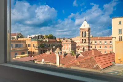 a view of a city with a clock tower and roofs at Splendido attico a Roma in Rome