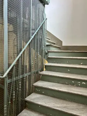 a stairway with a metal fence next to a building at Splendido attico a Roma in Rome