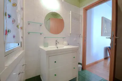a bathroom with a sink and a mirror at Splendido attico a Roma in Rome