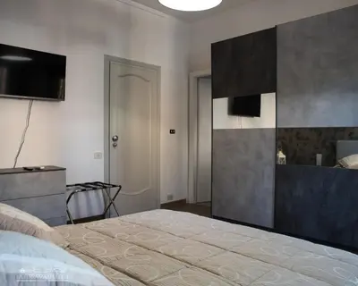 a bedroom with a bed and a flat screen tv at B&B La Terrazza sui Colli in Rome